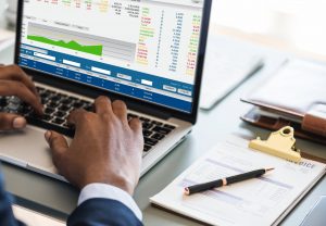 Man on computer looking over numbers