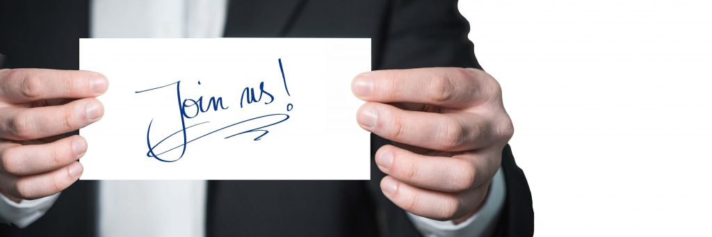 Man holding Join Us sign